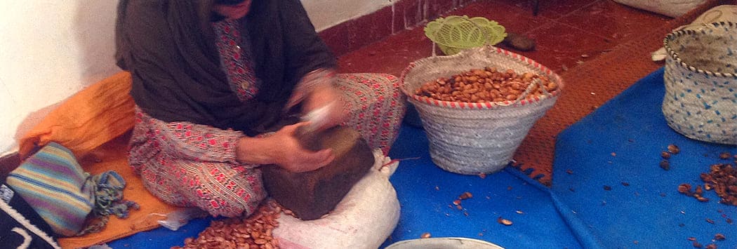 argan nuts are hand cracked with stone Berber women using stone to crack open hard argan nuts