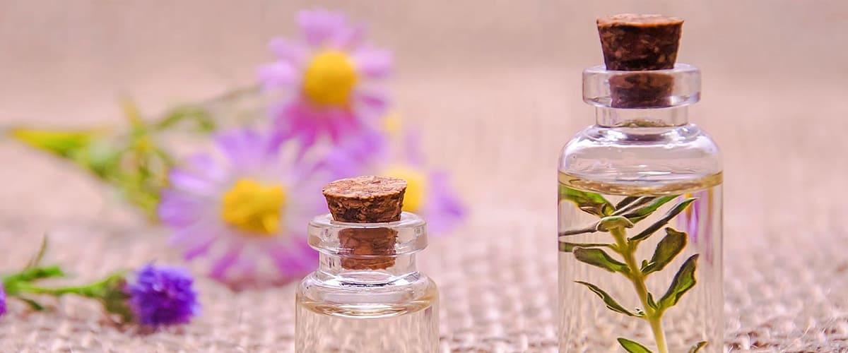 article about hair growth table with small coloured bottles of essential oils