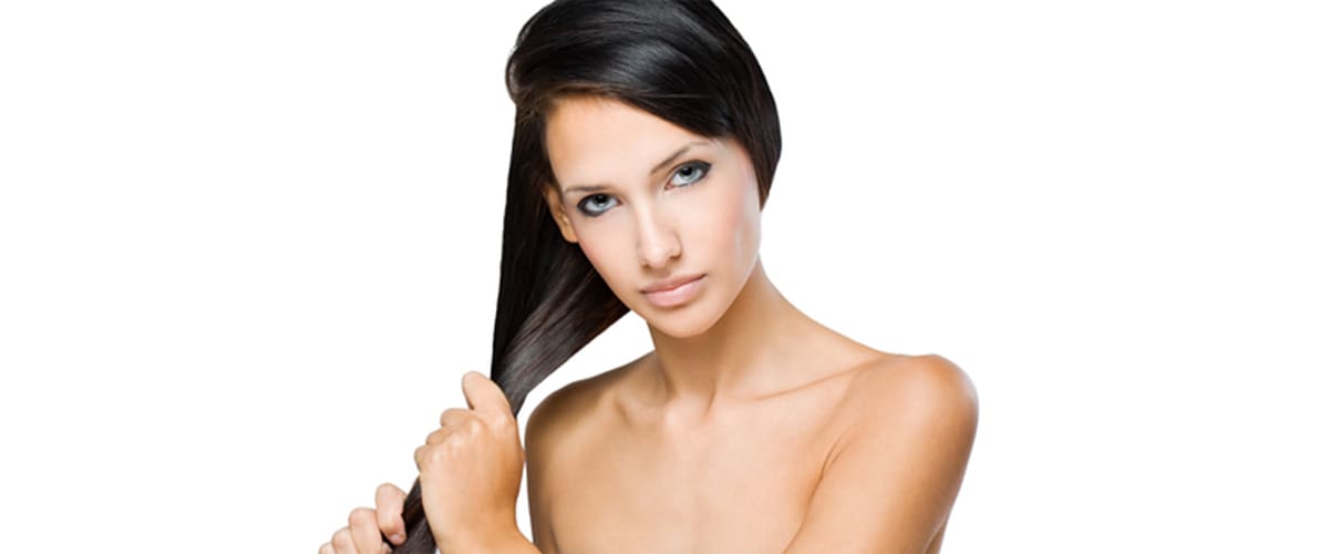 stronger hair with argan oil image of woman pulling on strong black hair